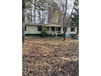 Single-wide mobile home with front porch and large yard at 4197 Hwy 162, Covington, GA 30016