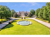 Stunning estate with circular drive, manicured lawn, and elegant fountain at 5200 Moore Rd, Suwanee, GA 30024