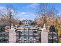 Elegant gated estate featuring a circular drive and impressive fountain at 5200 Moore Rd, Suwanee, GA 30024