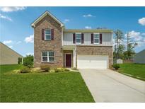 Charming two-story brick home with a well-manicured lawn and a two car garage at 7247 Emma Ct, Douglasville, GA 30134