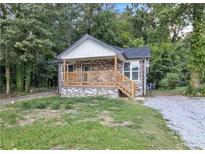 Brick house with a front porch and landscaped yard at 3017 Delmar Ln, Atlanta, GA 30311
