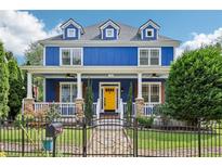 Charming blue two-story home with a welcoming front porch and a bright yellow front door at 930 Custer St, Atlanta, GA 30354