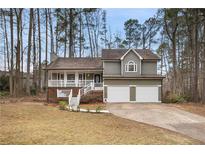 Charming two-story home with a well-manicured front yard and attached two-car garage at 54 Cross Branches, Acworth, GA 30101