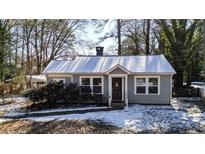 Gray house with white trim and snow covered yard at 2505 Mellville Ave, Decatur, GA 30032