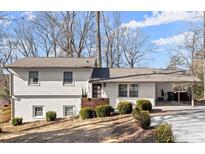 Charming ranch home with white brick exterior, updated landscaping, and a covered carport at 3384 Campbell Se Rd, Smyrna, GA 30080