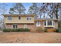 Brick and wood two-story house with a large yard at 4745 Elam Forest Dr, Stone Mountain, GA 30083