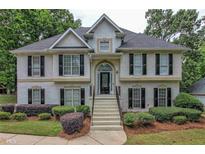 Two-story house with a large front porch and manicured lawn at 113 Willow Hill Ln, Stockbridge, GA 30281