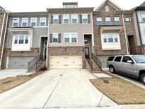 Modern three-story townhome with attached two-car garage and walkway at 208 Spike Trl, Smyrna, GA 30080