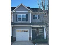 Gray townhome with white garage door and stone accents at 532 Oakside Pl, Acworth, GA 30102