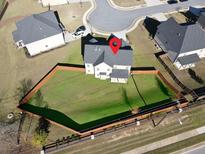A lovely aerial view of a fenced in back yard and the back of the house at 799 Blue Juniper Cir, Loganville, GA 30052
