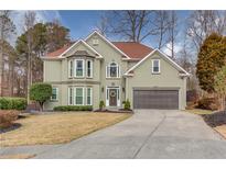 Charming two-story home with a well-manicured lawn, a two-car garage, and a traditional architectural design at 1692 Branch Creek Cv, Lawrenceville, GA 30043