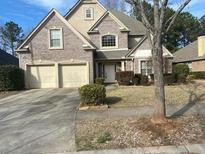 Charming two-story brick home with a well-maintained lawn and two car garage at 7981 Gossamer Dr, Fairburn, GA 30213