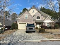 Charming two-story brick home with a well-manicured front yard and a two-car garage at 7981 Gossamer Dr, Fairburn, GA 30213