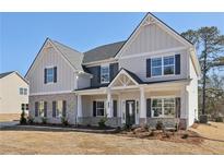 Charming two-story home featuring a mix of gray siding and brick accents at 1421 Stephens View Dr, Loganville, GA 30052