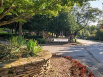 Community entrance to Vinings Central Condominiums, featuring a stone sign and landscaping at 2776 Vinings Central Se Dr # 19, Atlanta, GA 30339