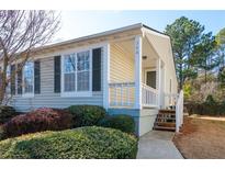 Tan colored house with white porch and landscaping at 366 Oak Harbor Trl, Marietta, GA 30066