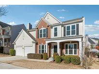 Two-story brick home with a large front yard and attached two-car garage at 3648 Ramsey Close Sw, Atlanta, GA 30331