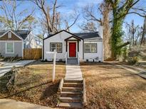 Newly renovated white house with red door, steps and walkway at 942 Lawton Sw St, Atlanta, GA 30310