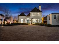 Stunning white two-story home with unique architectural details and landscaped yard at 230 Central Ave, Fayetteville, GA 30214