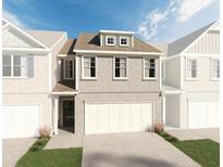 Two-story townhome with attached garage and brick exterior at 553 Cygnet Ln, Grayson, GA 30017