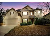 Two story house featuring brick facade, and a landscaped yard at 343 Gail Pond Dr, Lawrenceville, GA 30045