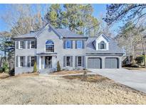 Two-story house with gray brick, gray shutters, and a two-car garage at 5702 Brynwood Nw Cir, Acworth, GA 30101