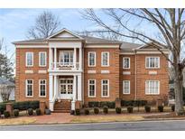 Brick two-story house with white columns and a manicured lawn at 3156 E Addison Dr, Alpharetta, GA 30022