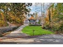 Beautiful home with a large green lawn and a long driveway at 3790 Narmore Ne Dr, Atlanta, GA 30319