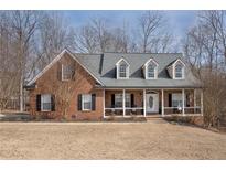 Brick house with front porch and large windows at 405 Marvin Ct, Mcdonough, GA 30252