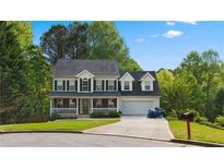 Two-story house with a gray roof, green shutters, and a large front yard at 3065 Willow Park Dr, Dacula, GA 30019