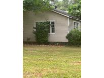 Charming home featuring vinyl siding, well-kept lawn, and mature landscaping for enhanced curb appeal at 4402 Highland Rd, Decatur, GA 30035