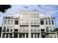 Modern townhouses with light brick exterior, balconies, and metal railings at 919 Hughley Se Cir # 72, Atlanta, GA 30316
