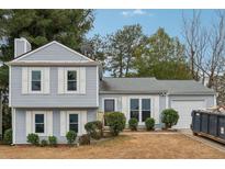 Charming two-story house with gray siding, white trim, and a well-maintained lawn at 1259 Mill Lake Cir, Stone Mountain, GA 30088