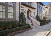 Elegant brick building exterior with manicured landscaping and a welcoming entrance at 6736 Cadence Blvd, Sandy Springs, GA 30328