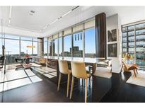 Bright kitchen features large island with seating and amazing city views through the floor-to-ceiling windows at 1065 Peachtree Ne St # 3102, Atlanta, GA 30309