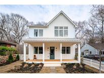 Charming two-story white farmhouse with a welcoming front porch and well-manicured landscaping at 185 Marion # B, Atlanta, GA 30307