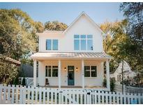 Two-story white farmhouse with a front porch and picket fence at 185 Marion # B, Atlanta, GA 30307