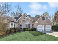 Brick house with two-car garage and landscaped lawn at 1263 Irwin Lake Way, Marietta, GA 30064