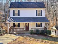 Two-story house with white siding, dark roof, and a front porch at 2920 Fleetwood Dr, Cumming, GA 30041