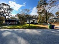 Charming single-story homes with well-maintained lawns on a tree-lined street at 524 Jetal Nw Pl, Atlanta, GA 30318