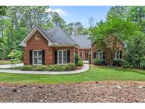 Brick house with a landscaped lawn and walkway at 25 Highlands Way, Oxford, GA 30054