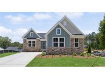 Charming single-Gathering home featuring stone accents, manicured lawn, and a private driveway under a bright blue sky at 14 Cambridge Ln, Dallas, GA 30157