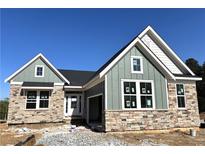 Charming single-Gathering home featuring stone accents, green siding, and a welcoming front entrance at 14 Cambridge Ln, Dallas, GA 30157