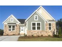 Charming new construction home with a stone and siding exterior and manicured lawn at 14 Cambridge Ln, Dallas, GA 30157