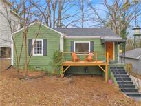 Charming green house with deck, steps, and landscaping at 1783 Pennington Se Pl, Atlanta, GA 30316