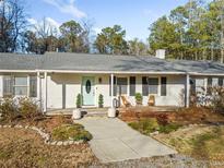 White brick ranch house with gray roof, large windows, and a covered porch at 2715 County Line Nw Rd, Acworth, GA 30101