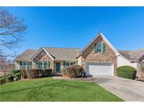 Ranch style home with stone accents and a two-car garage at 604 Landing Way, Loganville, GA 30052