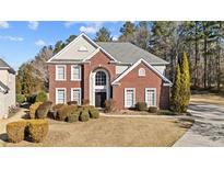 Brick two-story house with landscaped yard and driveway at 3164 Sw Wolf Club Sw Dr, Atlanta, GA 30349