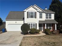 Two-story house with gray roof, white siding, and landscaping at 7645 Broadhurst Dr, Riverdale, GA 30296