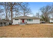 Newly renovated ranch home with red door and landscaped yard at 3215 Concord Cir, Smyrna, GA 30080